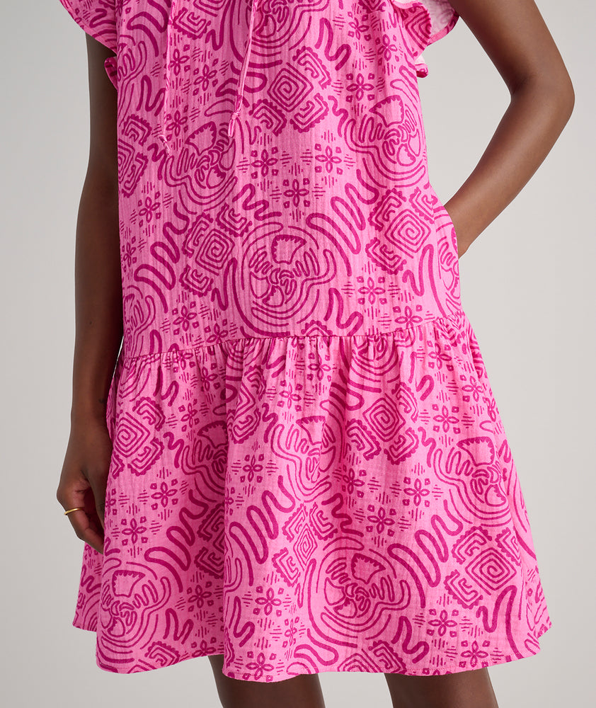 Model is wearing UNTUCKit Arya dress in pink print.