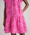 Model is wearing UNTUCKit Arya dress in pink print.