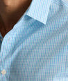Model is wearing UNTUCKit Ashbourne cottentek shirt in checkered blue. 