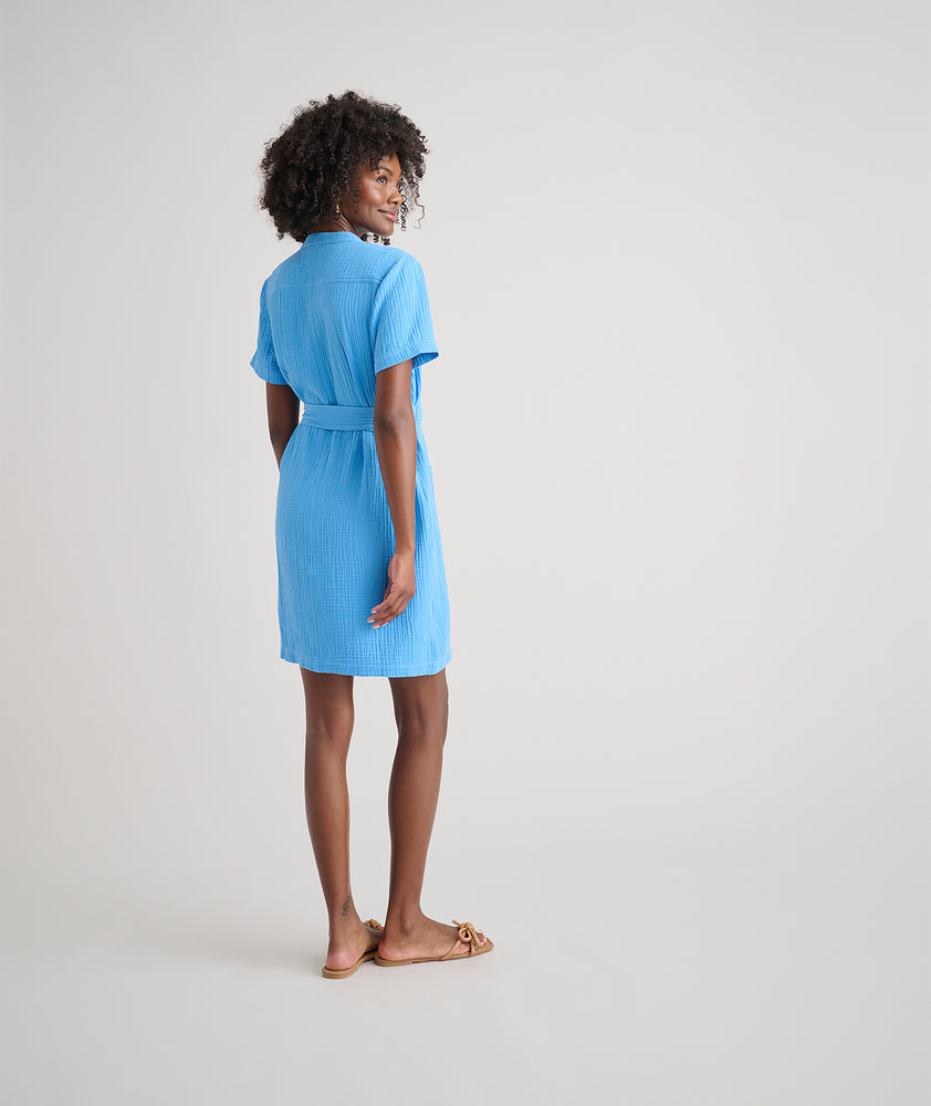 Model is wearing UNTUCKit avry dress in solid blue. 