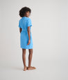 Model is wearing UNTUCKit avry dress in solid blue. 