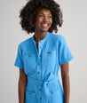 Model is wearing UNTUCKit avry dress in solid blue. 
