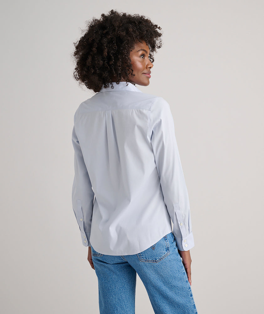 Model is wearing UNTUCKit Bella shirt in blue. 