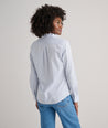 Model is wearing UNTUCKit Bella shirt in blue. 