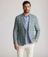 Model is wearing UNTUCKit Bartrand sport coat in windowpane green. 