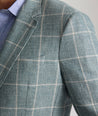 Model is wearing UNTUCKit Bartrand sport coat in windowpane green. 
