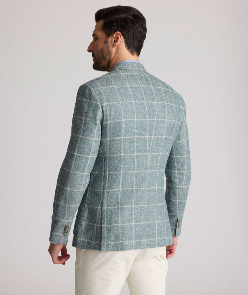 Model is wearing UNTUCKit Bartrand sport coat in windowpane green. 