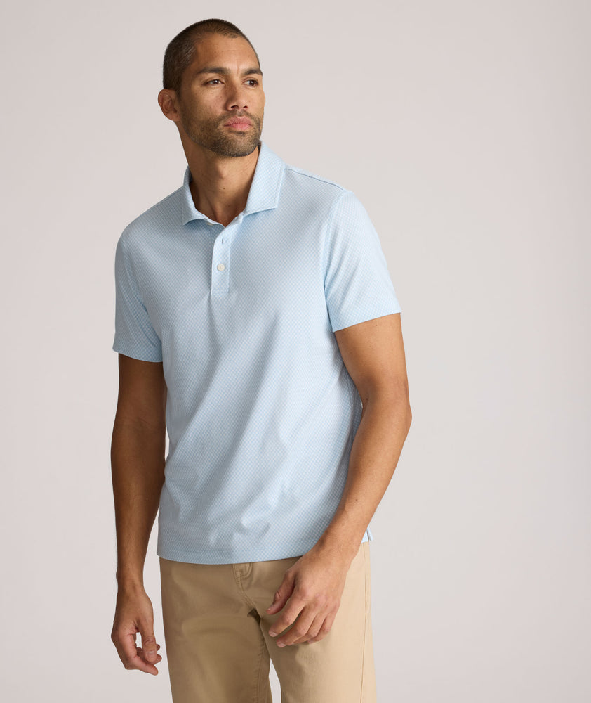 Model is wearing UNTUCKit Chen wrinkle free polo in blue. 
