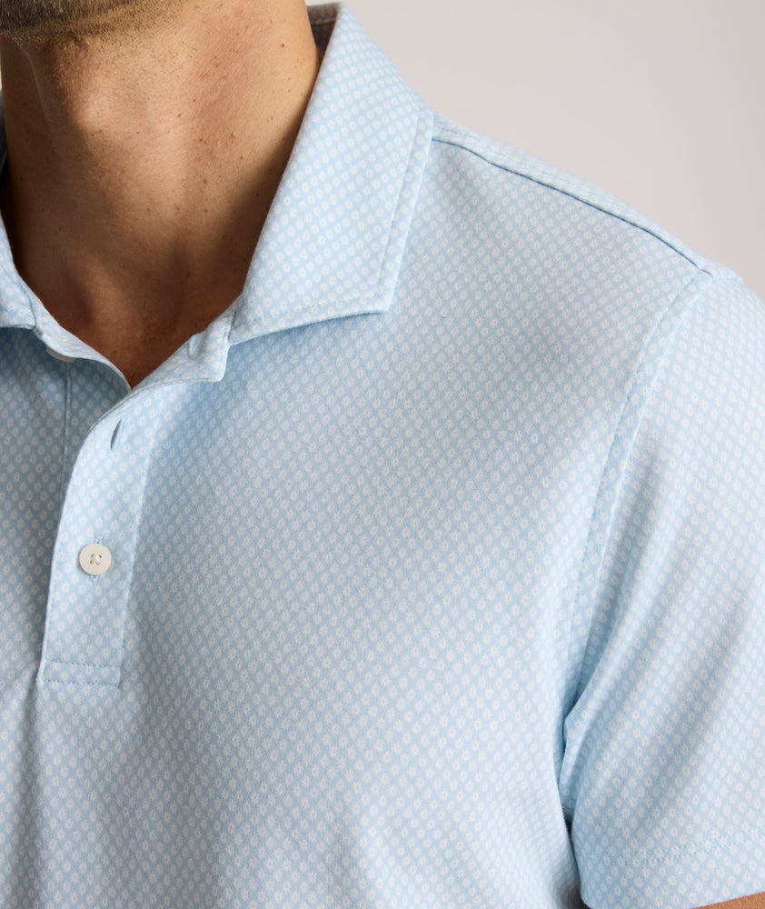 Model is wearing UNTUCKit Chen wrinkle free polo in blue. 