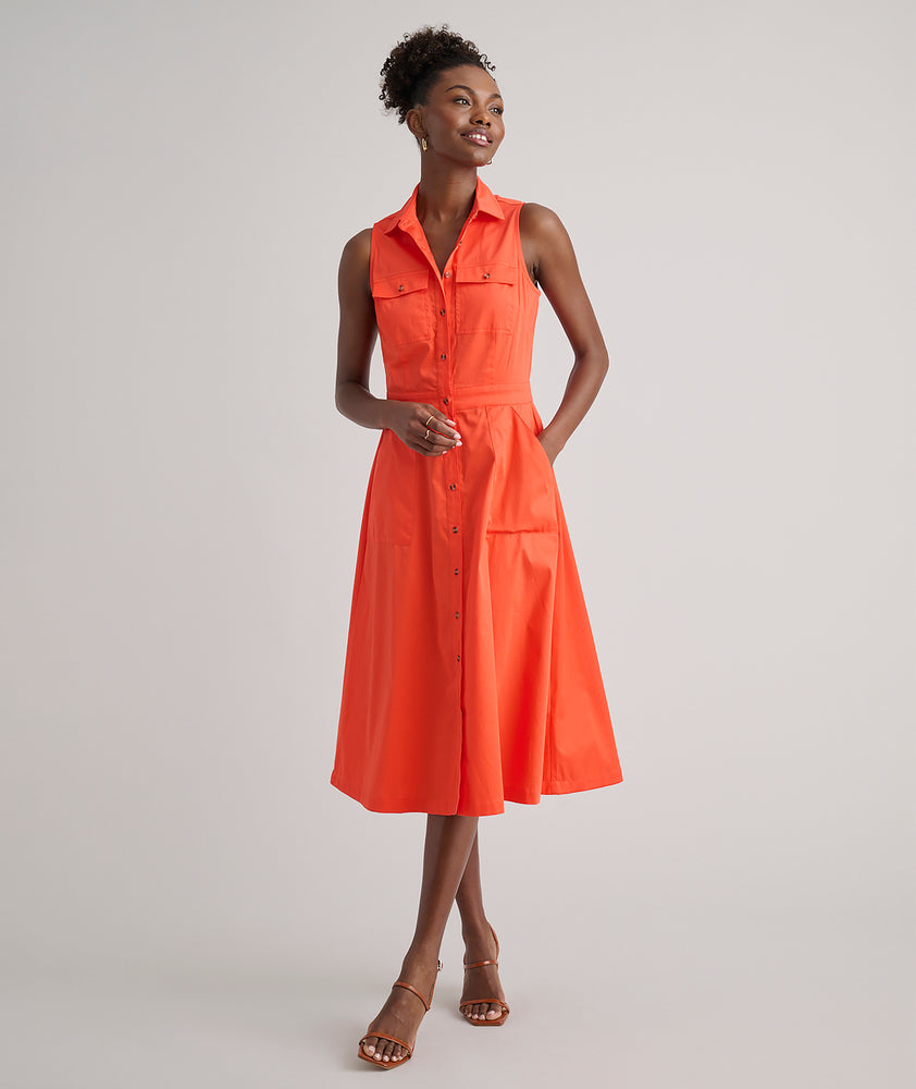 Model is wearing UNTUCKit Codelia dress in solid orange. 