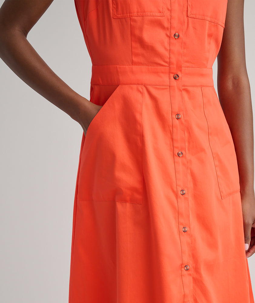 Model is wearing UNTUCKit Codelia dress in solid orange. 
