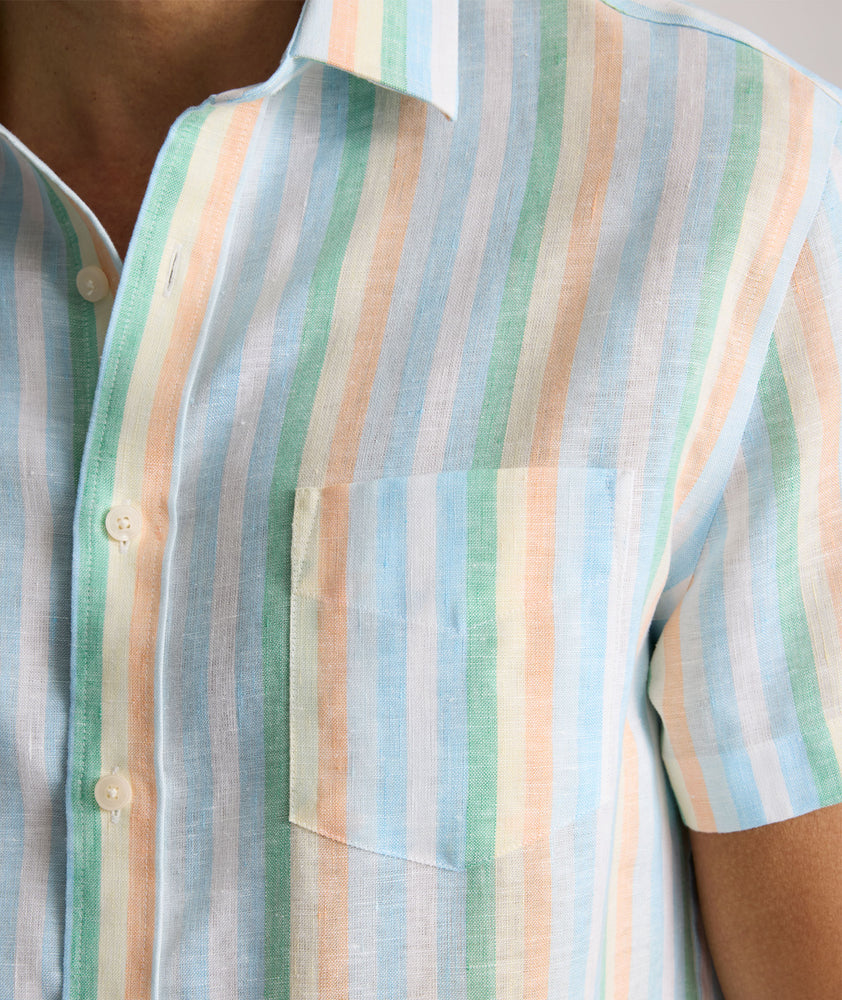 Model is wearing UNTUCKit darby wrinkle-free shirt in rainbow stripe. 