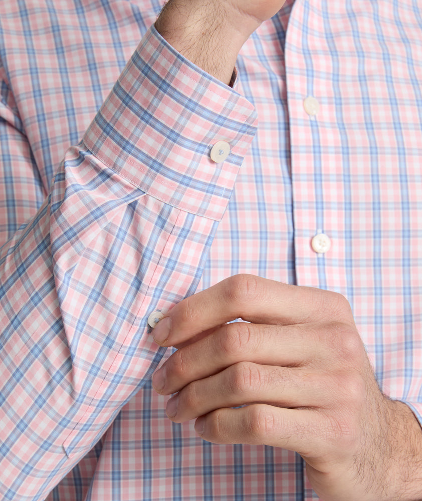 Model is wearing UNTUCKit Fairchild wrinkle free shirt in pink. 