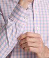 Model is wearing UNTUCKit Fairchild wrinkle free shirt in pink. 