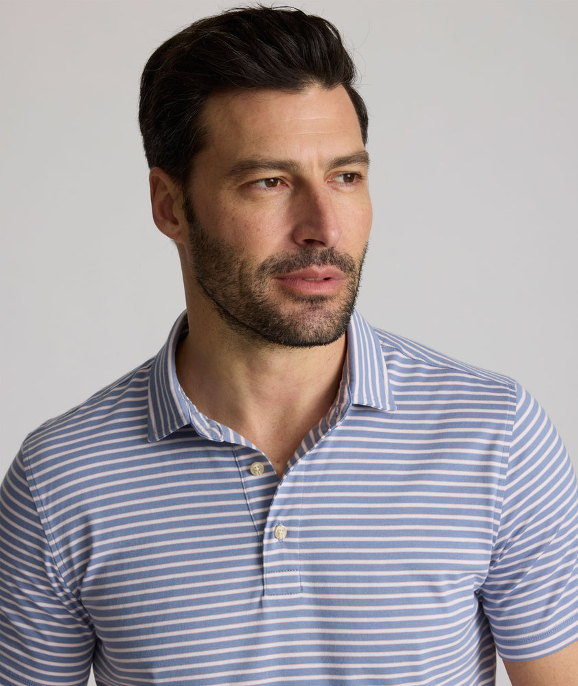 Model is wearing UNTUCKit Fernandez polo in stonewash.