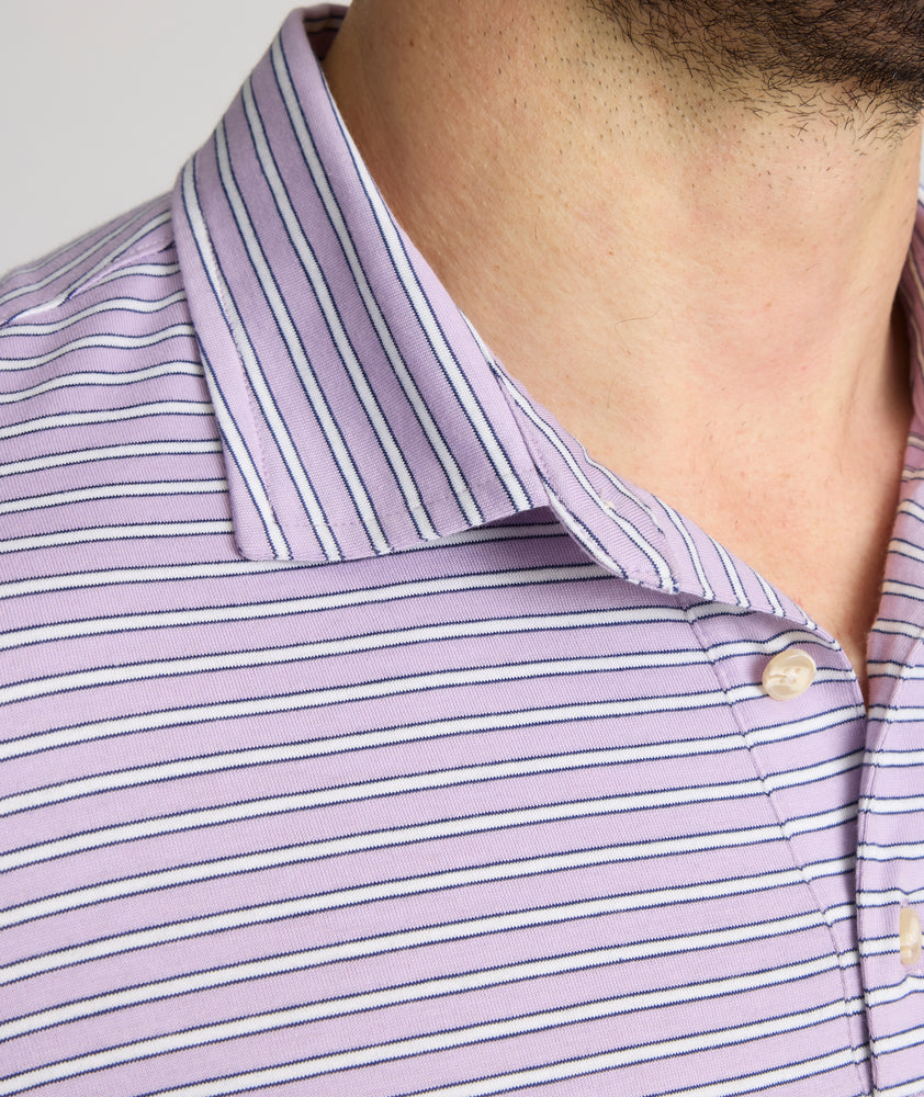 Model is wearing UNTUCKit Fernandez polo in lavender. 