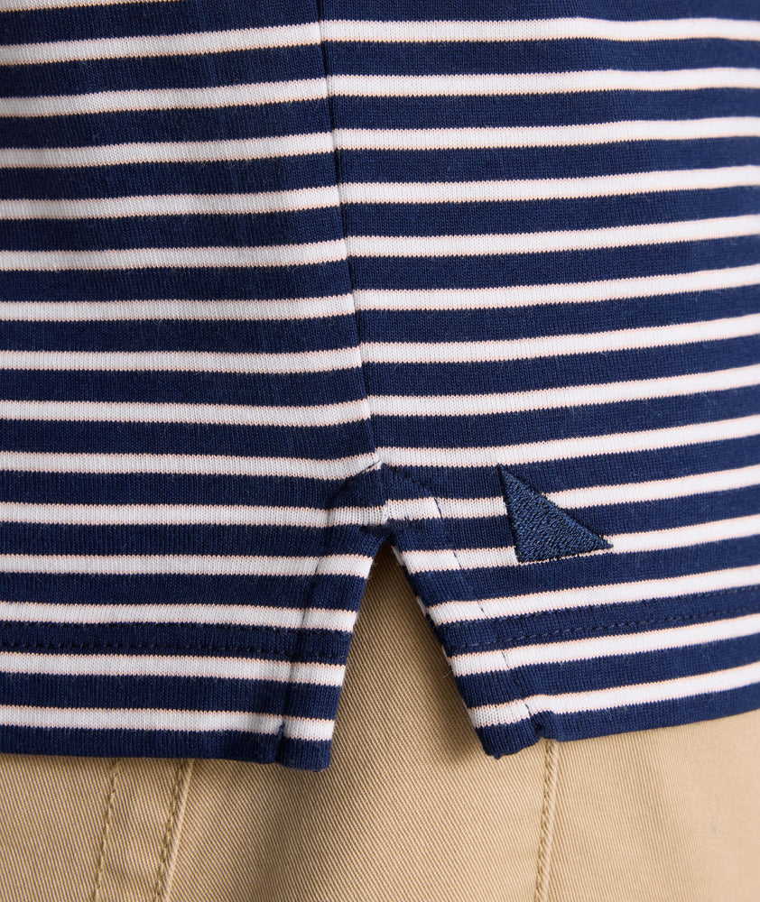 Model is wearing UNTUCKit Fernandez Striped Performance Polo in Blue Print.