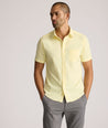 Model is wearing UNTUCKit Gironde short sleeve performance  shirt in light yellow. 