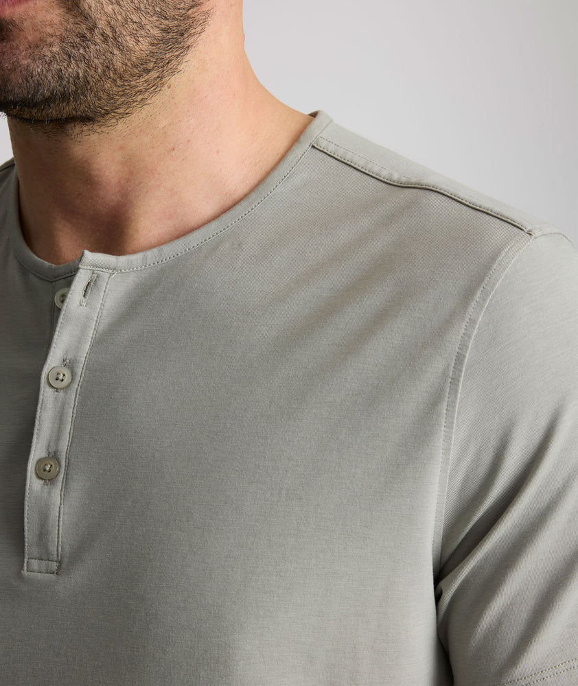 Model wearing an UNTUCKit Military Green Essential Henley in EcoSoft™.