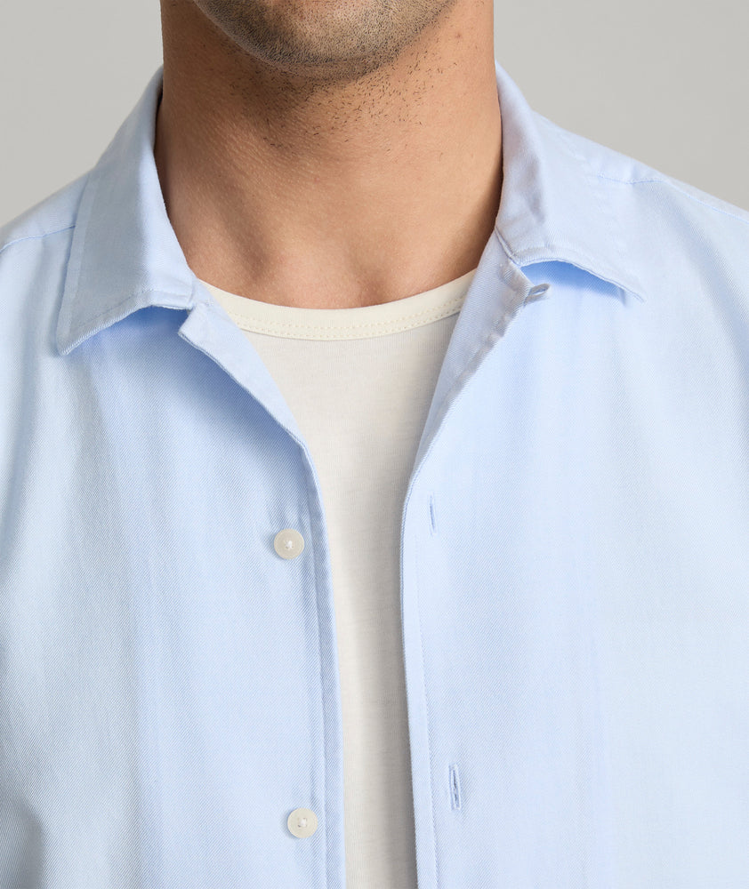 Model is wearing UNTUCKit Hughes in light blue. 