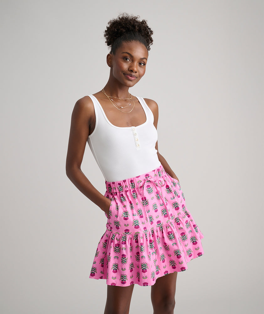 Model is wearing UNTUCKit Ilona skirt in pink. 