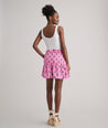 Model is wearing UNTUCKit Ilona skirt in pink. 
