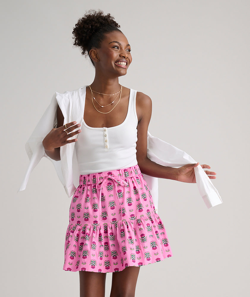 Model is wearing UNTUCKit Ilona skirt in pink. 