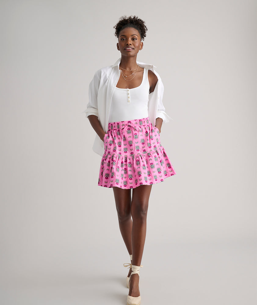 Model is wearing UNTUCKit Ilona skirt in pink. 