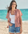 Model is wearing UNTUCKit Jamie shirt in strawberry print. 