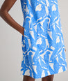 Model is wearing UNTUCKit Jordan printed birds dress in blue. 