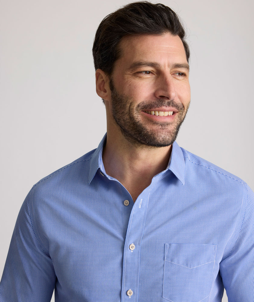 Model is wearing UNTUCKit Kelly wrinkle free shirt in blue gingham.