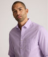 Model is wearing UNTUCKit Kelly wrinkle free shirt in purple gingham.