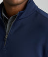 Model is wearing UNTUCKit performance sweatshirt in navy.