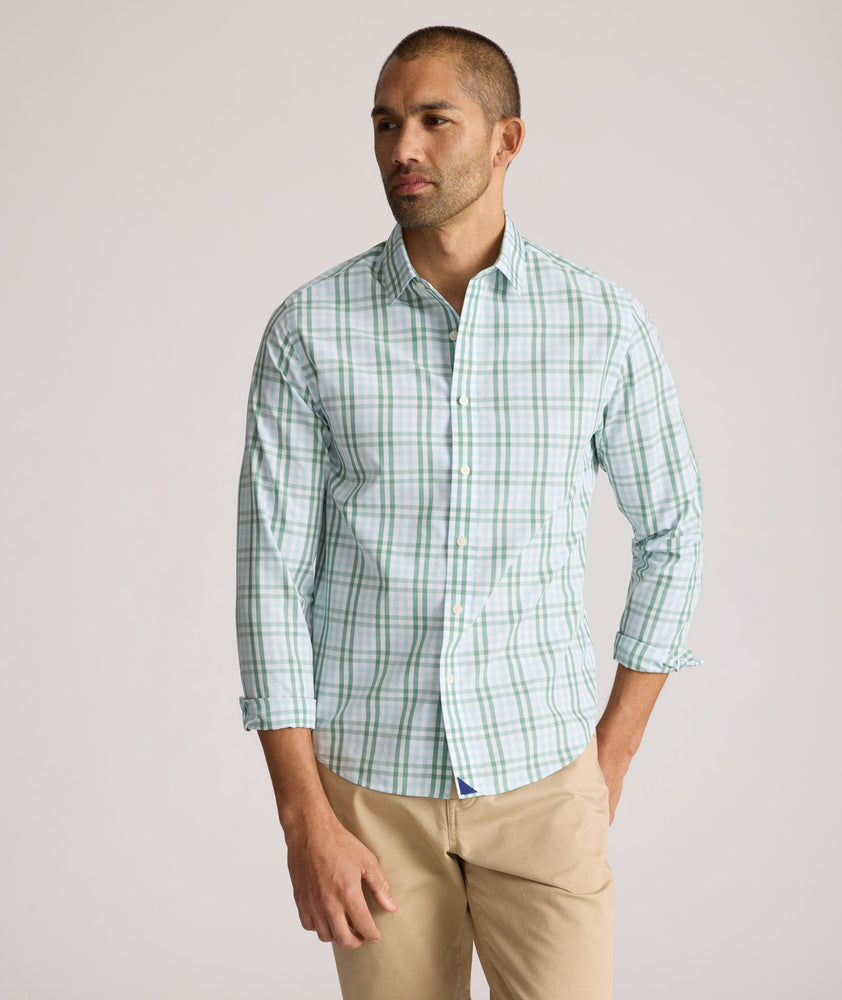 Model is wearing UNTUCKit Quigley wrinkle free shirt in check. 