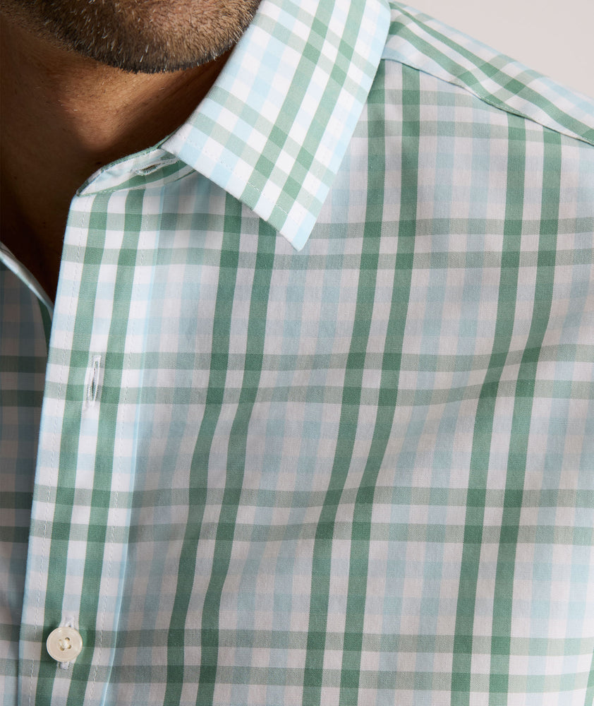Model is wearing UNTUCKit Quigley wrinkle free shirt in check. 