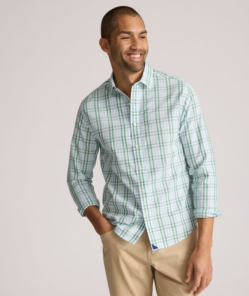 Model is wearing UNTUCKit Quigley wrinkle free shirt in check. 