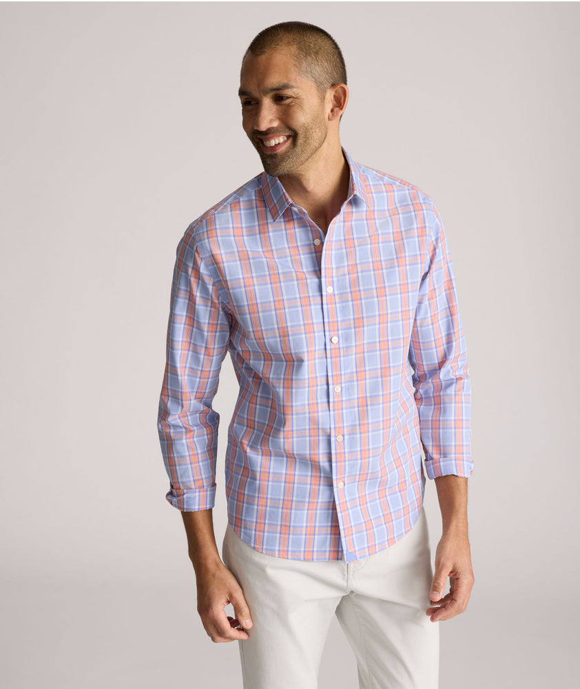 Model is wearing UNTUCKit ravenswood wrinkle free plaid plaid shirt in orange. 