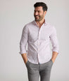 Model is wearing UNTUCKit Raynard cottentek shirt in pink windowpane. 