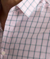 Model is wearing UNTUCKit Raynard cottentek shirt in pink windowpane. 