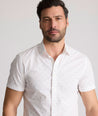 Model is wearing UNTUCKit Rockwell short sleeve cotton shirt. 