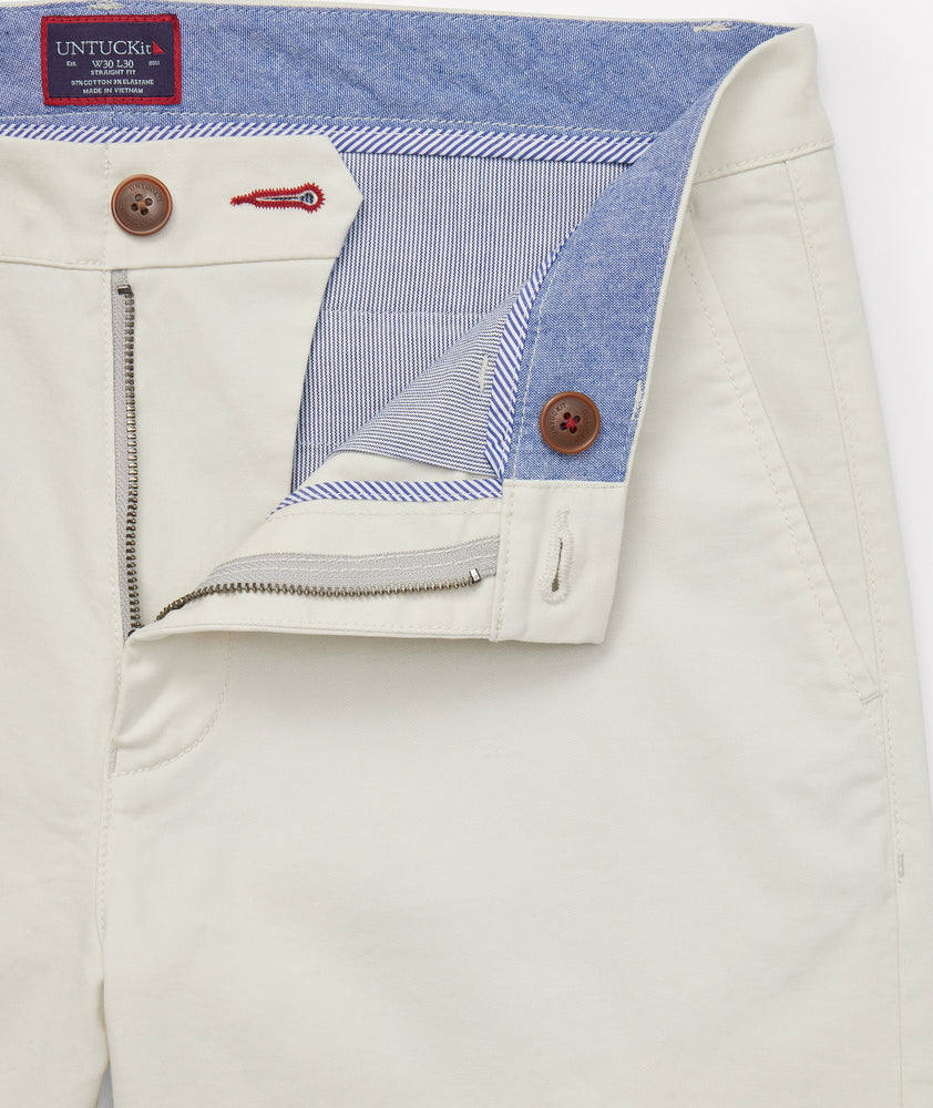 Model is wearing UNTUCKit Classic Chino Pants in Stone Gray.