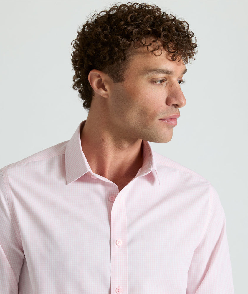 Model is wearing Travers shirt in pink. 