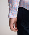 Model is wearing UNTUCKit trembley cottontek orange check shirt. 