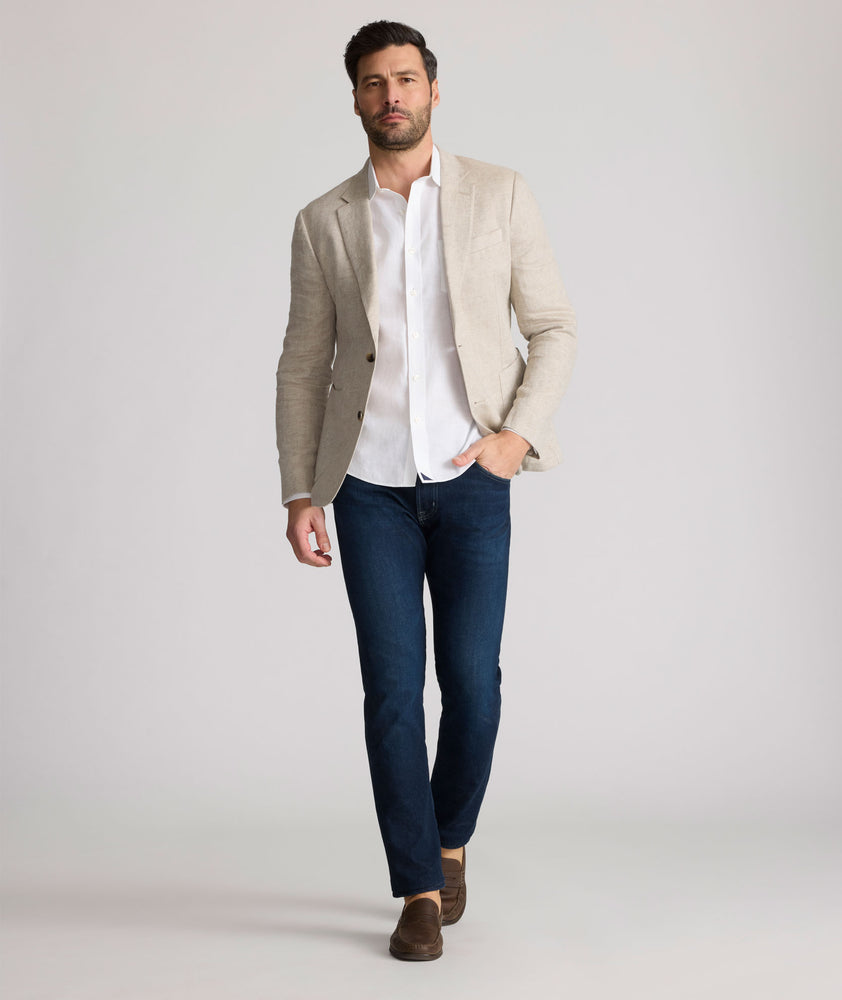 Model is wearing UNTUCKit Whittle tan sport coat. 