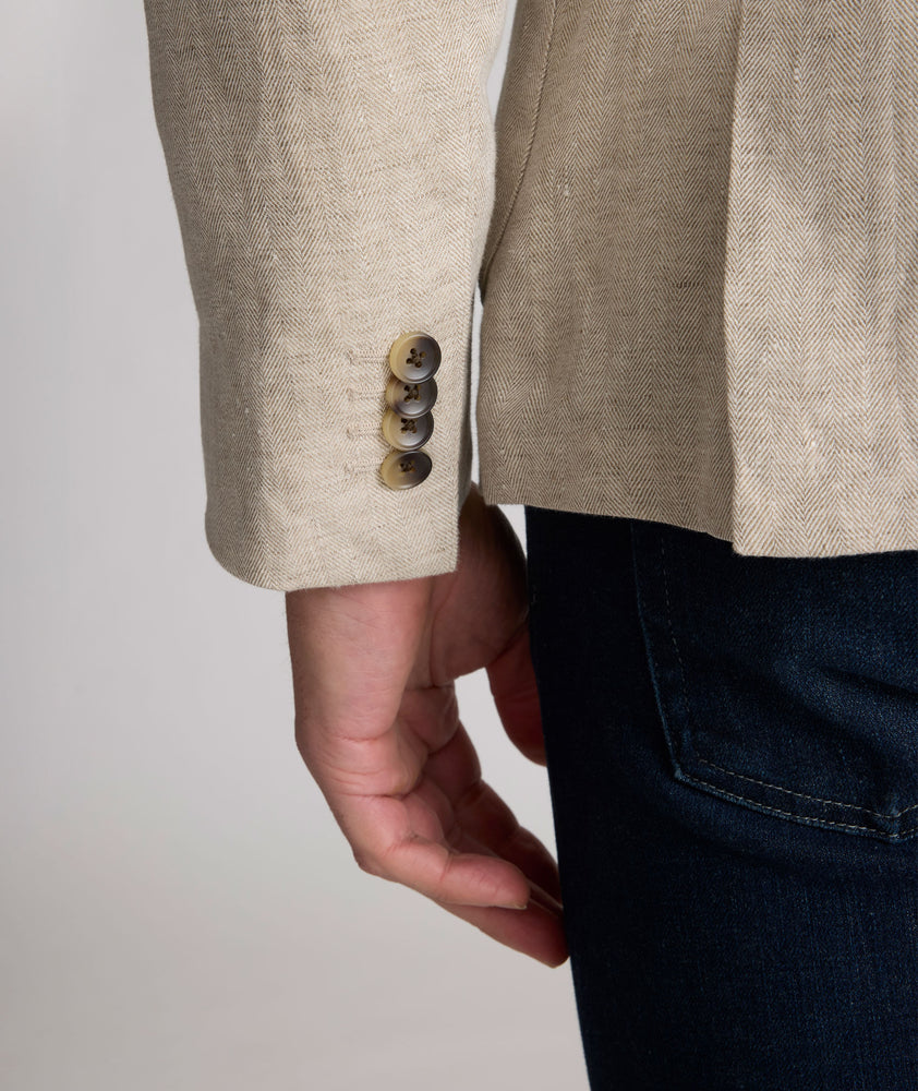 Model is wearing UNTUCKit Whittle tan sport coat. 
