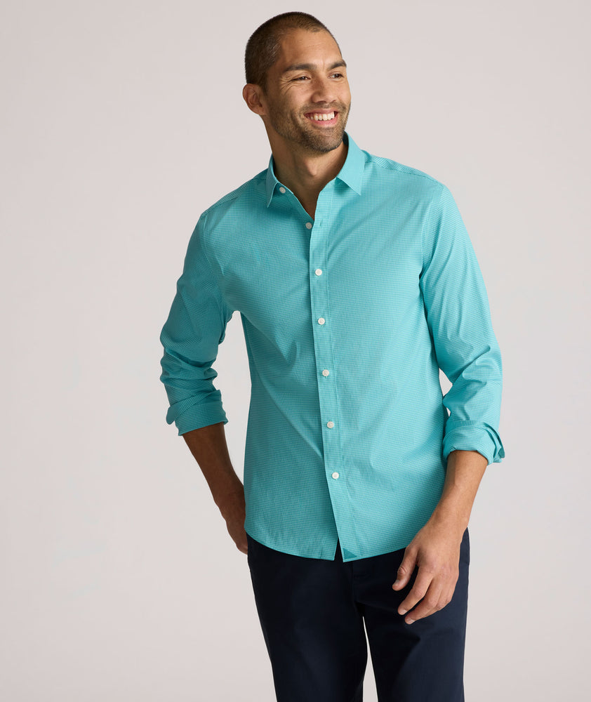 Model is wearing UNTUCKit Yorksley performance shirt in in teal tiny gingham. 