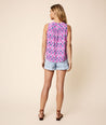 Model is wearing UNTUCKit purple and navy Sleeveless Popover Connie Shirt.
